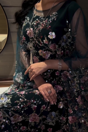Hand embroidery on the sleeves and chest, featuring sparkling golden details.